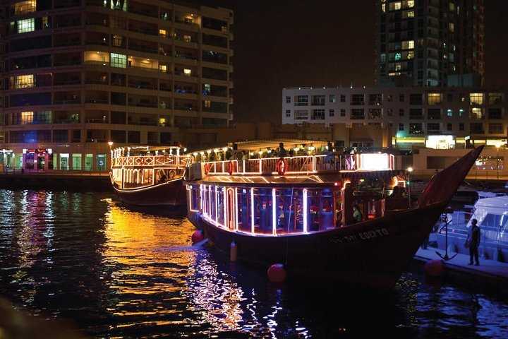 Experience a delightful dhow cruise along Dubai Creek savoring delicious cuisine while soaking in stunning views of illuminated skyline landmarks on this unique evening adventure.